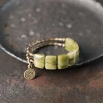 澈曜橄曜·Reikinn Peridot & Rudraksha Bracelet — BSM175 Oriental Edition | Coral Stone · Brass Double Row · Handmade Unisex Jewelry for Protection & Prosperity